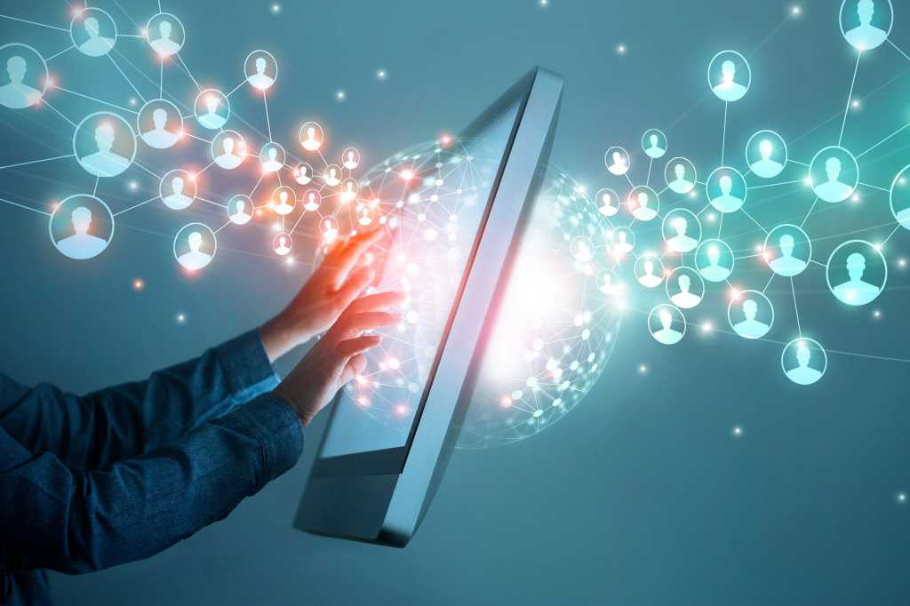 Leading remote teams  >  A businessman virtually works with a distributed network of teams.